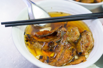 Bun Cha with grilled pork, rice noodles, vegetable and soup in vietnamese cuisine and street foods on VIETNAM HANOI