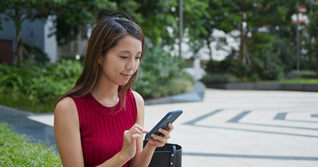 Fototapeta premium Woman use of mobile phone at street