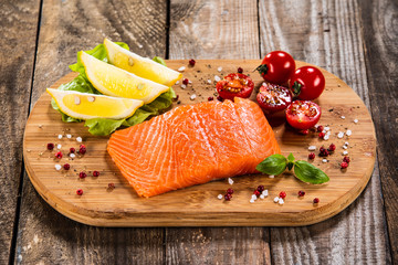 Fresh raw salmon fillets on cutting board