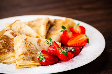 Crepes with cream and strawberries