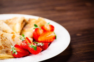 Crepes with cream and strawberries