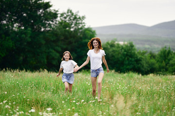 Fototapeta premium happy mother and daughter in the park