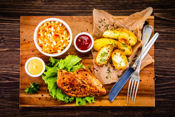 Grilled chicken fillet with baked potatoes and vegetables