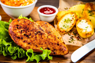 Grilled chicken fillet with baked potatoes and vegetables