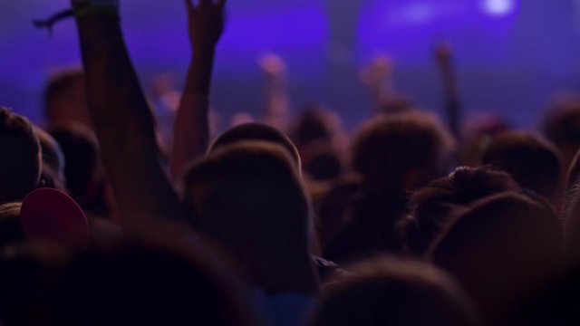 People crowd dancing on discotheque on club party. The light blinking with blue. 4K