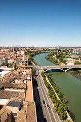 Zaragoza city in Spain. Aerial cityscape view over Ebro river with stone bridge .