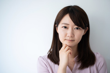 Young business woman thinking against white background