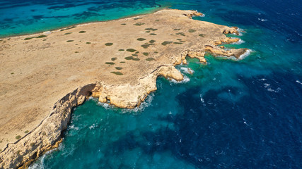 Aerial drone photo of small islet of Glaronisi with paradise emerald clear sea rocky beaches, Koufonisi island, Small Cyclades, Greece