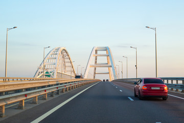 White arches of the bridge over the Kerch passage in Russia at dawn on a summer day
