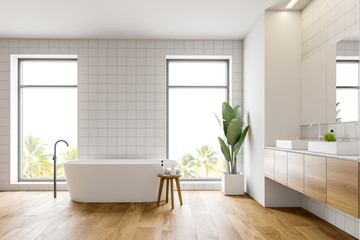 Side view of white bathroom with tub and sink