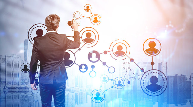 Businessman drawing social network icons in city