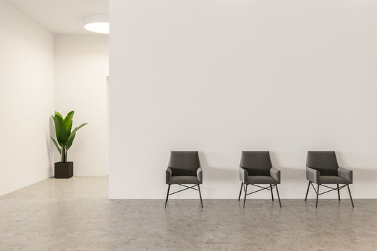 Waiting room with armchairs in white office
