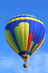 Ballons Festival - Balloon Festival, exhibition of hot-air balloons in the city park. Hot air balloon in flight against a background of blue sky.