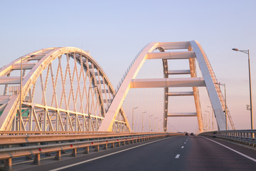 The large white arches of the Crimean bridge in Russia in the morning at dawn