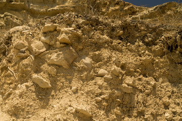 Cracked yellow rock with dry grass
