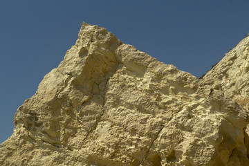 Yellow mountain rock in front of blue sky