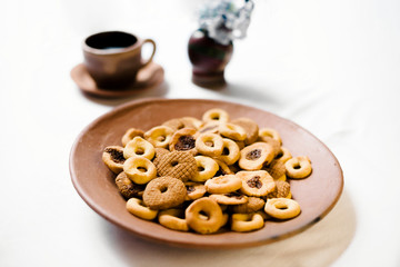 Rosquillas, viejitas and rosquetes on a handmade clay plate with a cup of coffee. No people. 