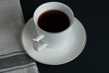 Obraz na płótnie Canvas coffee in white cup dark background