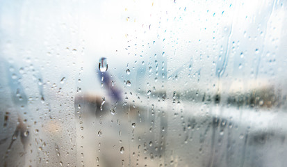 Raindrops on window glass On Airplane