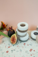 jar of luxury eyeshadow on terrazzo dish, pink background, flower decoration, copy space