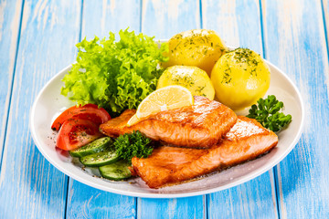 Grilled salmon with boiled potatoes and vegetable salad