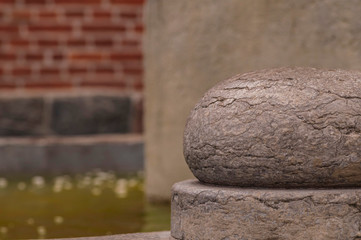 Round figure on the background of a blurred fountain