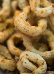 Delicious deep fried rings of squid close up.