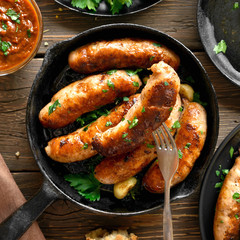 Fried sausages in frying pan