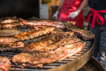 Cooking pork ribs on a grill. Meat on a grills.