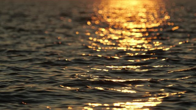 View of a deep sea rippling water surface reflecting the sunlight.