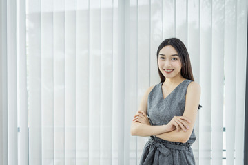 Portrait of beautiful young businesswoman working  in the office.,standing on workplace.,Happy working.