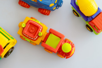 Naklejka premium toy cars on the table.Children's playroom with plastic colorful educational blocks toys. Games floor for preschoolers kindergarten. interior children's room. Free space. 
