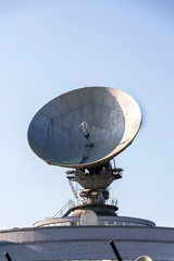 Radar antenna on satellite links center, telecommunication tower, wireless communication concept, clear blue sky on a sunny day