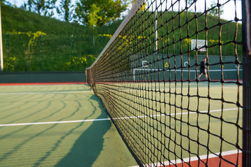 Tennis court net close up in sunny day.