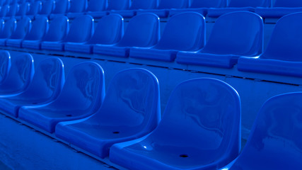 Fototapeta premium Bleachers in a sports stadium. Blue Seats In A Row