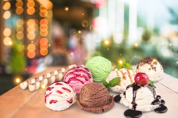 Ice cream scoops with vanilla, chocolate and berry scoops and topping