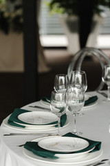 Served for wedding restaurant table with dishes, glasses,  cutlery