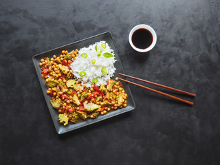 Curry with chickpeas and cauliflower. Rice side dish. Asian cuisine. Top view.