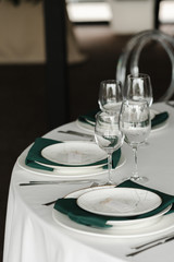 Served for wedding restaurant table with dishes, glasses,  cutlery