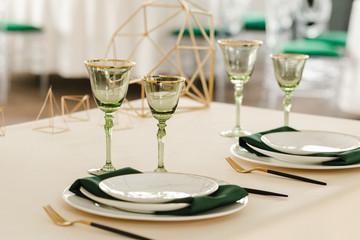 Served for wedding restaurant table with dishes, glasses,  cutlery