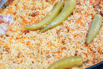 Traditional delicious pilaf with vegetables in a cauldron