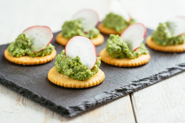 Pea and Radish Leaf Pesto Spread on Crackers