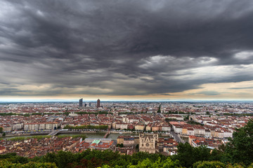 Fototapeta na wymiar Panorama of the city of Lyon, France, under a menacing sky full of dark gray clouds