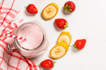 Strawberry milkshake or smoothie in mason jar.