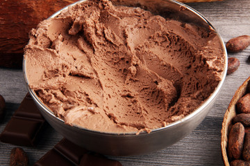 Chocolate coffee ice cream in a bowl on rustic white table
