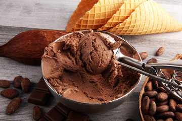 Chocolate coffee ice cream in a bowl on rustic white table