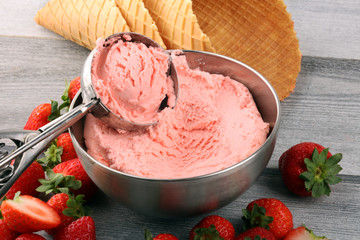 Strawberry ice cream scoop on a rustic white background