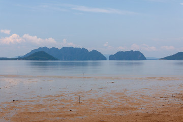 Beautiful tropical beach view from the island with mountains on the background.