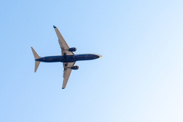 plane flies airplane in blue sky summer