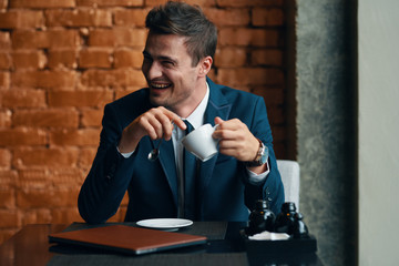 businessman drinking coffee in his office